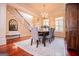 Formal dining room with hardwood floors, chandelier, and views of the staircase at 713 Birkdale Blvd, Carrollton, GA 30116