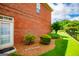 Brick exterior with green landscaping including green trimmed bushes and a door at 713 Birkdale Blvd, Carrollton, GA 30116