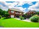 Brick home with a second story deck overlooks landscaped yard and fencing at 713 Birkdale Blvd, Carrollton, GA 30116