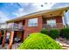 Two-story brick home featuring a second-story balcony and well-maintained landscaping at 713 Birkdale Blvd, Carrollton, GA 30116