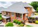 Stunning brick home boasts an outdoor balcony and patio seating with meticulously maintained landscaping at 713 Birkdale Blvd, Carrollton, GA 30116