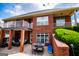 Brick home with a covered patio area, outdoor dining set, and manicured greenery at 713 Birkdale Blvd, Carrollton, GA 30116