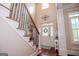 Bright foyer with hardwood floors, staircase, front door, and transom window at 713 Birkdale Blvd, Carrollton, GA 30116