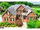 Beautiful two-story brick home featuring a manicured front yard with lush landscaping at 713 Birkdale Blvd, Carrollton, GA 30116
