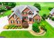 Beautiful two-story brick home featuring a manicured front yard with lush landscaping at 713 Birkdale Blvd, Carrollton, GA 30116