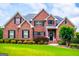 Beautiful brick home featuring a well-manicured lawn and lush landscaping at 713 Birkdale Blvd, Carrollton, GA 30116
