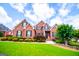 Charming brick home with meticulous landscaping under a bright sky at 713 Birkdale Blvd, Carrollton, GA 30116