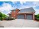 Three car garage with an expansive driveway and manicured shrubs at 713 Birkdale Blvd, Carrollton, GA 30116