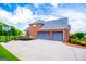 Side view of brick house with three-car garage and a well-maintained lawn at 713 Birkdale Blvd, Carrollton, GA 30116