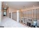 View of the upstairs hallway with elegant iron railing overlooking the formal living room with a fireplace and piano at 713 Birkdale Blvd, Carrollton, GA 30116