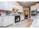 Bright kitchen featuring white cabinets, stainless appliances, tile backsplash, and grey walls at 713 Birkdale Blvd, Carrollton, GA 30116