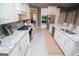 Modern kitchen with white cabinets, stainless appliances, and marble countertops, ample counter space at 713 Birkdale Blvd, Carrollton, GA 30116