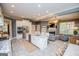 Open concept kitchen features an island with seating, stainless steel appliances, and granite countertops at 713 Birkdale Blvd, Carrollton, GA 30116