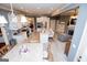 Open-concept kitchen with granite countertops, stainless steel appliances, and adjacent dining area with white cabinets at 713 Birkdale Blvd, Carrollton, GA 30116