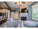 Cozy living room with fireplace, neutral tones, and a view into the bright kitchen at 713 Birkdale Blvd, Carrollton, GA 30116