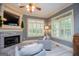 Cozy living room with a fireplace, large windows with shutters, and comfortable seating at 713 Birkdale Blvd, Carrollton, GA 30116
