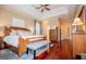 Main bedroom with wood floors, a tray ceiling, a sitting area, and ensuite bath at 713 Birkdale Blvd, Carrollton, GA 30116