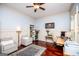 Home office with hardwood floors, wainscoting, and built-in shelving, lit by natural light at 713 Birkdale Blvd, Carrollton, GA 30116