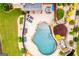Top-down view of an in-ground pool surrounded by lounge chairs, with lush greenery and an outdoor dining area at 713 Birkdale Blvd, Carrollton, GA 30116