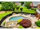 Relaxing private pool features a stone trim and black fencing with stone benches nearby at 713 Birkdale Blvd, Carrollton, GA 30116
