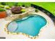 Aerial view of the gorgeous kidney bean shaped pool with a built-in waterfall at 713 Birkdale Blvd, Carrollton, GA 30116