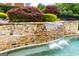 Beautiful pool with stone waterfall feature and lush landscaping at 713 Birkdale Blvd, Carrollton, GA 30116