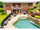Backyard showcasing a freeform swimming pool with waterfall feature, lounge chairs, and an outdoor dining area at 713 Birkdale Blvd, Carrollton, GA 30116