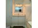Clean bathroom with vanity, framed mirror, storage cabinet, marble countertop, and updated fixtures at 360 Morgan Mill Rd, Brooks, GA 30205