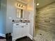 Modern bathroom featuring sleek vanity with granite countertops, light fixtures and walk-in shower at 360 Morgan Mill Rd, Brooks, GA 30205