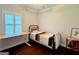 Cozy bedroom with hardwood floors, natural light, a decorative quilt, and functional workspace at 360 Morgan Mill Rd, Brooks, GA 30205