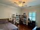 Bedroom showcasing natural light, hardwood floors, and modern shelving filled with decor at 360 Morgan Mill Rd, Brooks, GA 30205
