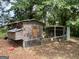 Rustic chicken coop with fenced enclosure, providing a secure and natural habitat at 360 Morgan Mill Rd, Brooks, GA 30205