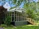 Charming exterior featuring a screened porch and staircase leading to backyard at 360 Morgan Mill Rd, Brooks, GA 30205