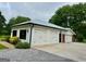 Spacious three car garage with white doors and modern black trim at 360 Morgan Mill Rd, Brooks, GA 30205