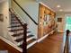 Hallway featuring staircase with wood detailing and decorative wall art at 360 Morgan Mill Rd, Brooks, GA 30205