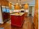 Charming kitchen featuring a red island, stainless steel appliances and wood flooring at 360 Morgan Mill Rd, Brooks, GA 30205