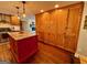 Bright kitchen showcasing a red island, wood cabinets, and wood flooring at 360 Morgan Mill Rd, Brooks, GA 30205