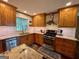 Well-lit kitchen featuring wood cabinets, stainless steel appliances, and granite countertops at 360 Morgan Mill Rd, Brooks, GA 30205
