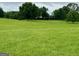 A view of a lush green field leading to a charming house in the distance at 360 Morgan Mill Rd, Brooks, GA 30205