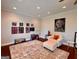 Bright living room featuring hardwood floors, custom art display, and cozy seating area with accent chair at 360 Morgan Mill Rd, Brooks, GA 30205