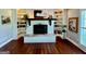 Inviting living room features a brick fireplace with built-in bookshelves and hardwood flooring at 360 Morgan Mill Rd, Brooks, GA 30205