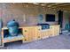 Outdoor kitchen features a built-in grill, Big Green Egg Smoker and a mounted television at 360 Morgan Mill Rd, Brooks, GA 30205