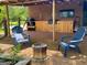 Outdoor patio features a cozy fire pit, comfortable seating and a custom kitchen on a brick patio at 360 Morgan Mill Rd, Brooks, GA 30205