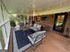 Screened-in porch with outdoor seating area and brick wall at 360 Morgan Mill Rd, Brooks, GA 30205