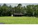 The backyard features a storage shed with lush green grass at 360 Morgan Mill Rd, Brooks, GA 30205