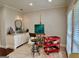 Bright studio with a vanity, art supplies, easel, and a red utility cart at 360 Morgan Mill Rd, Brooks, GA 30205
