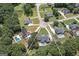 Aerial view of home in a cul-de-sac with pool, wooded area, and neighborhood at 245 Edenwylde Ct, Hampton, GA 30228