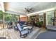 This is a covered outdoor patio with comfortable seating, a TV, and a grill in the backyard area at 245 Edenwylde Ct, Hampton, GA 30228