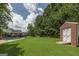 Spacious backyard features a storage shed, green grass, and an in-ground swimming pool at 245 Edenwylde Ct, Hampton, GA 30228