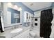 This is a bathroom that features a modern style with white cabinets, white tiling, and blue walls at 245 Edenwylde Ct, Hampton, GA 30228